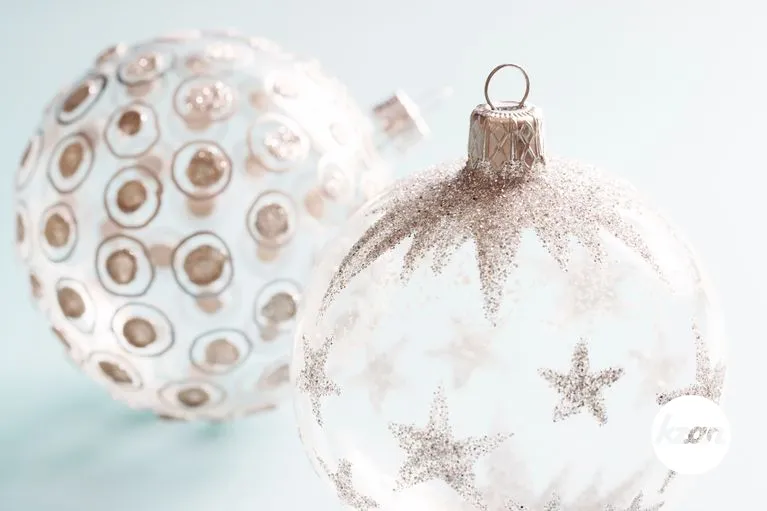 Decorated Christmas ornaments on a soft blue background.