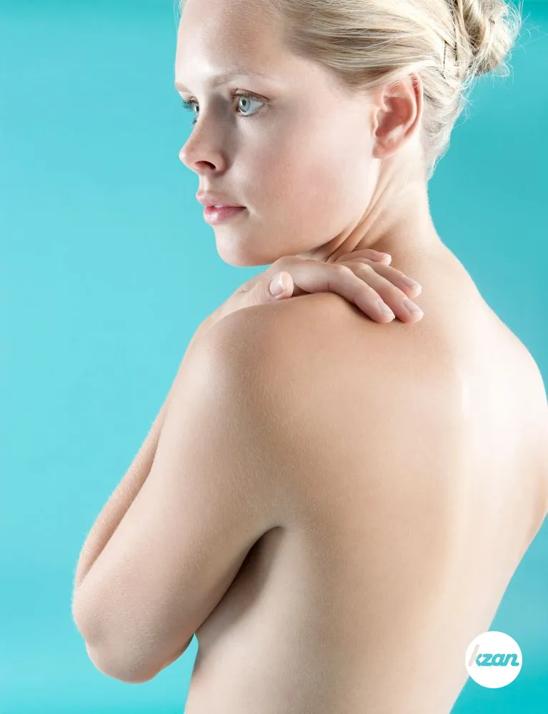 Side view of a woman's bare back and shoulder.