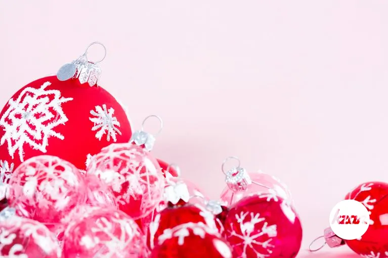 Still life of Christmas barballs on a pink background.
